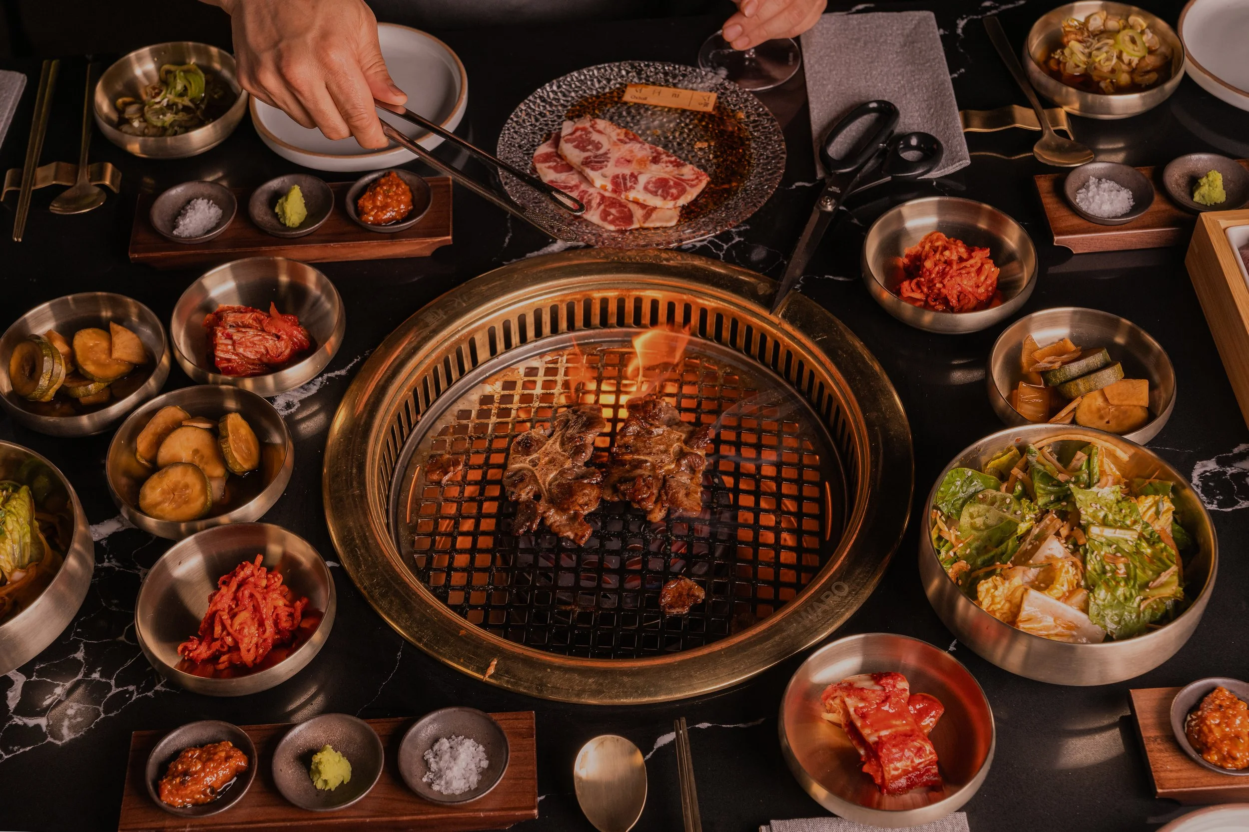 OLHSO House San Mateo Korean BBQ spread with banchan and grilled meat